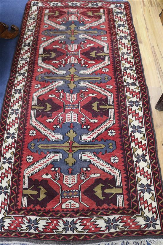 A Caucasian red ground runner, 200cm x 105cm
